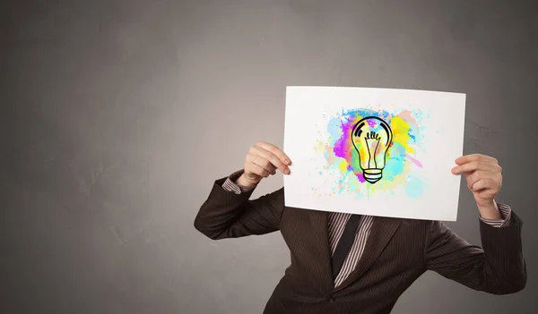 Person holding a paper with colorful bulb concept — Stock Photo, Image