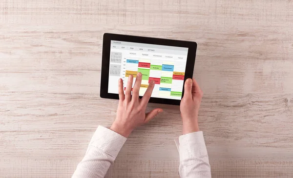 Hand holding tablet with timetable concept — Stock Photo, Image