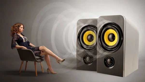 Young lady listening to big loudspeakers — Stock Photo, Image