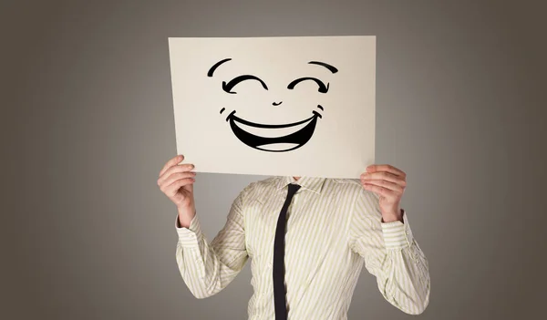 Bir kağıt doodle ifade yüzünün önünde tutan kişi — Stok fotoğraf