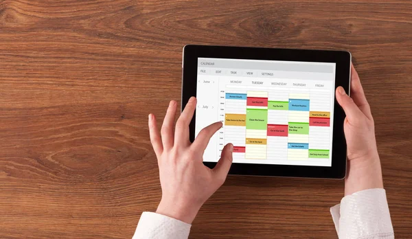 Hand holding tablet with timetable concept — Stock Photo, Image