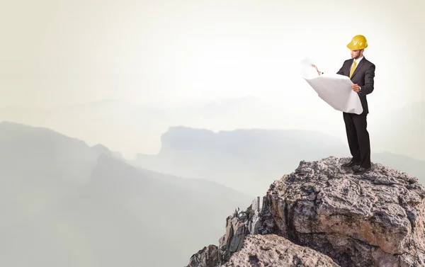 Business person on the top of the rock — Stock Photo, Image