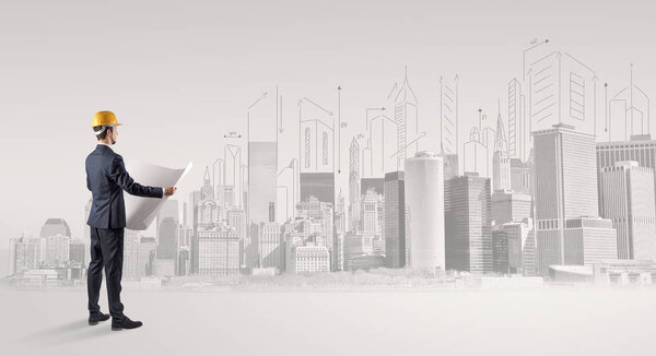 Architect standing and replanning a city panorama