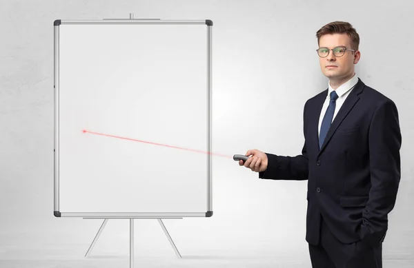 Businessman with laser pointer and copyspace white blackboard — Stock Photo, Image