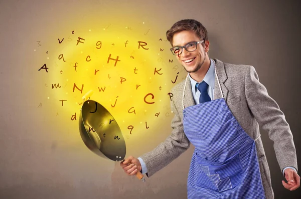 Person cooking letters in wok — Stock Photo, Image