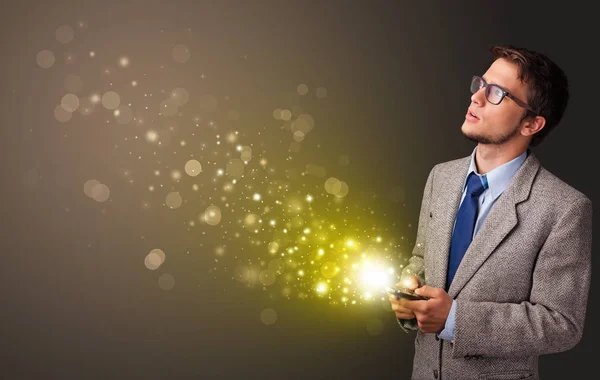 Using phone with gold sparkling concept — Stock Photo, Image