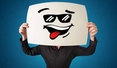Person holding a paper with cool emoticon face clipart