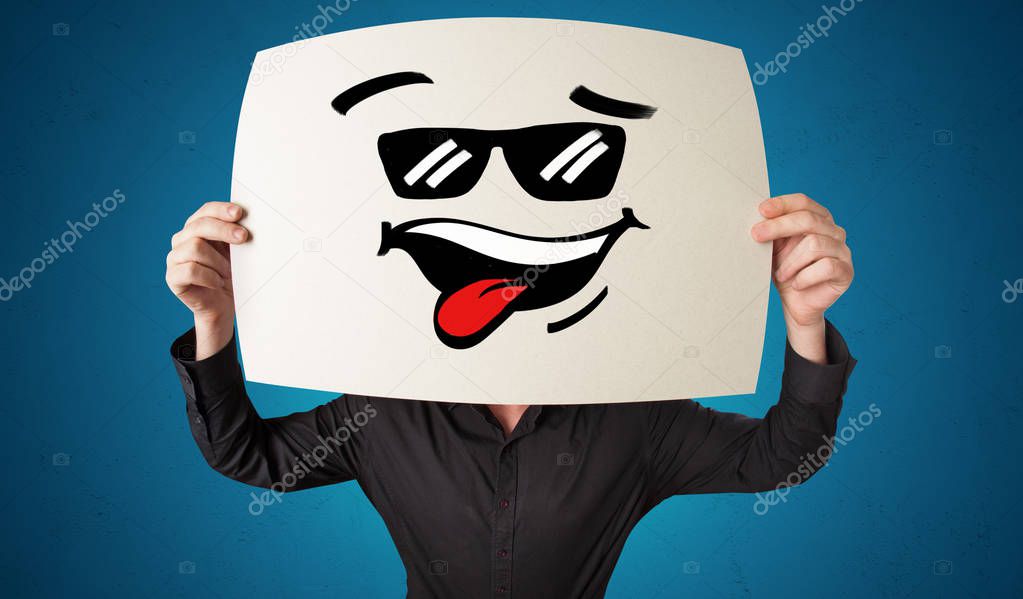 Person holding a paper with cool emoticon face