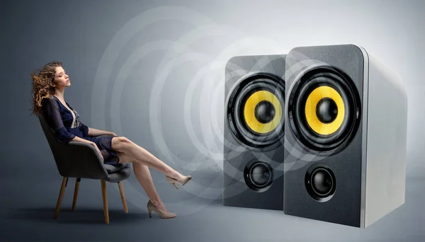 Young lady listening to big loudspeakers — Stock Photo, Image