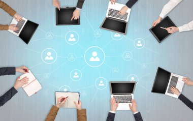 Dizüstü bilgisayarlar ve office konseptiyle tablet üzerinde çalışan bir grup ile aygıt içinde insan eller