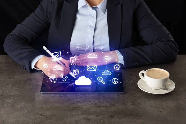 Business woman working on tablet with application symbols above — Stock Photo, Image