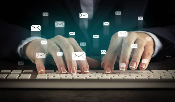 Woman typing on keyboard with chat icons around — Stock Photo, Image