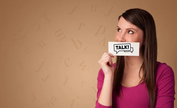 Person holding card in front of his mouth — Stock Photo, Image