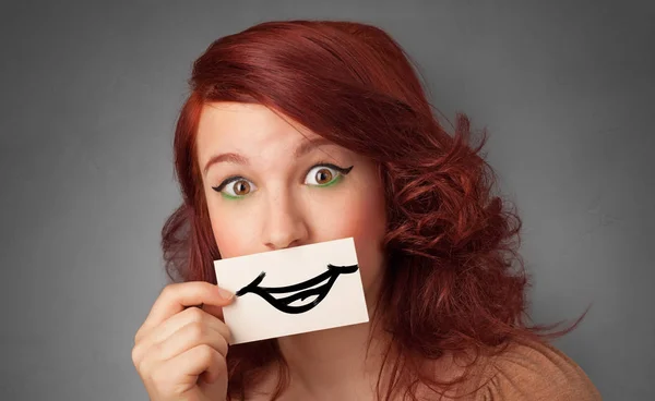 Person holding in front of her mouth a card — Stock Photo, Image