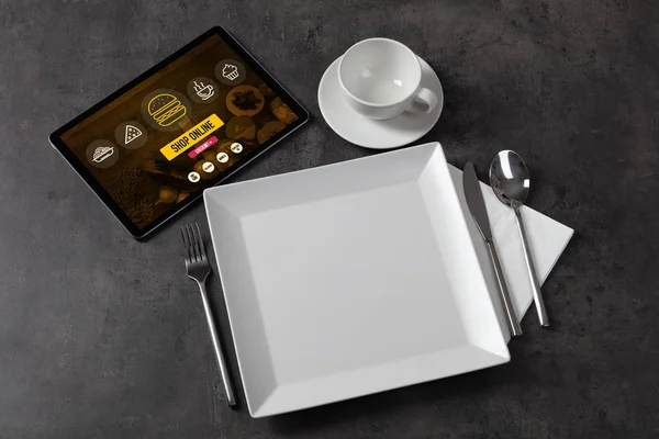 Online food order concept on laid table