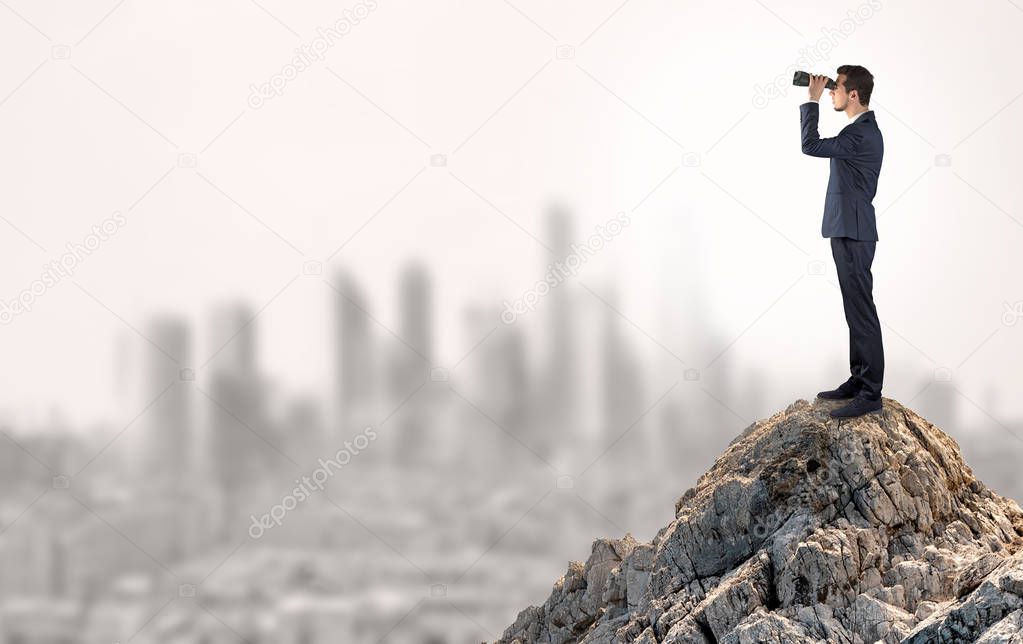 Business person looking to the city from distance