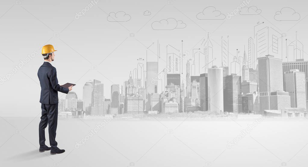 Architect standing and replanning a city panorama