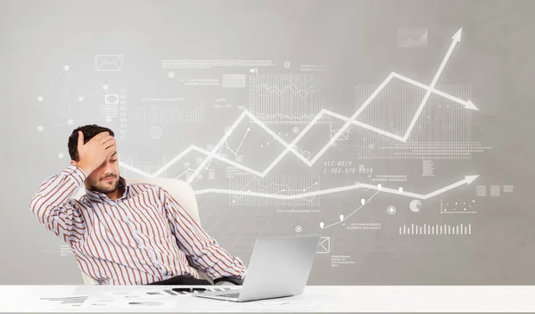 Business person sitting at desk with financial change concept — Stock Photo, Image