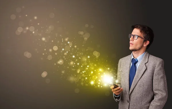 Using phone with gold sparkling concept — Stock Photo, Image