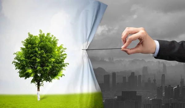 Hand pulling nature cityscape curtain to gray cityscape — Stock Photo, Image