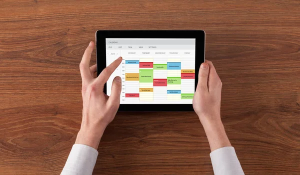 Hand holding tablet with timetable concept — Stock Photo, Image