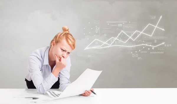 Business person sitting at desk with financial change concept — Stock Photo, Image