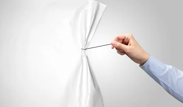 Hand pulling white paper curtain — Stock Photo, Image