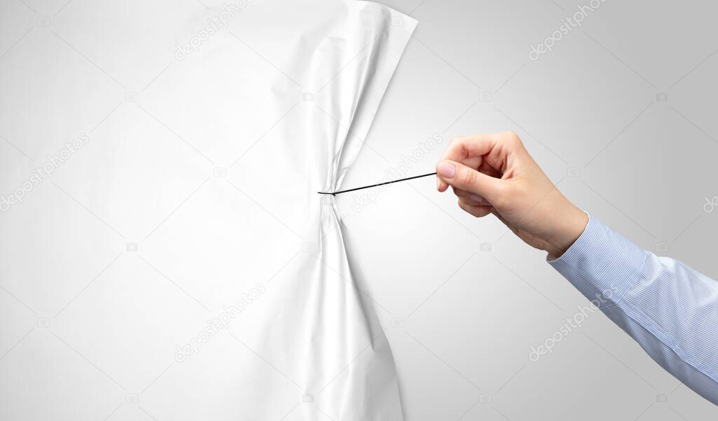 hand pulling white paper curtain