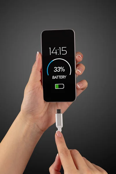 Hand charging phone with low battery — Stock Photo, Image