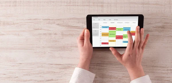 Hand holding tablet with timetable concept — Stock Photo, Image