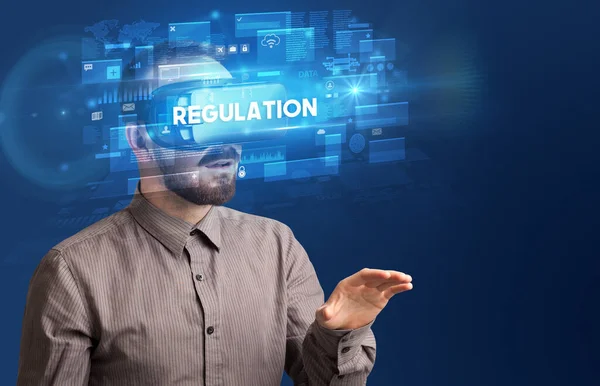 Businessman looking through Virtual Reality glasses — Stock Photo, Image
