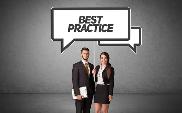 Business person in casual holding road sign — Stock Photo, Image