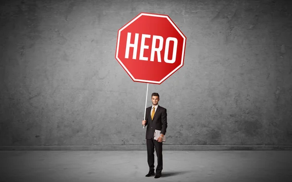 Young business person holding road sign — Stock Photo, Image