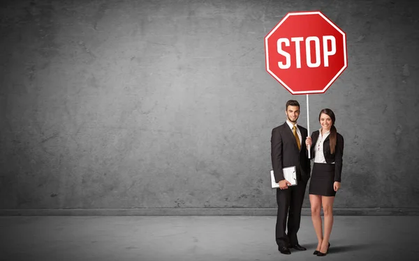 Young business person holding road sign — Stock Photo, Image