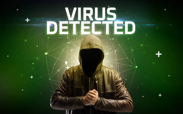 Faceless hacker at work with ROOTKIT VIRUS inscription, Computer