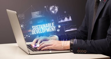 Dizüstü bilgisayar ve iş konsepti üzerinde çalışan iş adamı