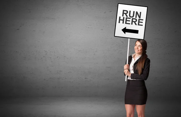 Business person holding a traffic sign — Stock Photo, Image