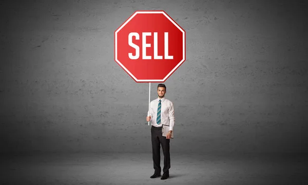 Young business person holding road sign — Stock Photo, Image