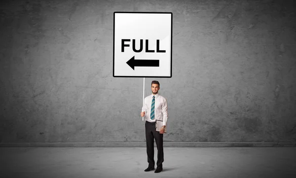 Business person holding a traffic sign — Stock Photo, Image