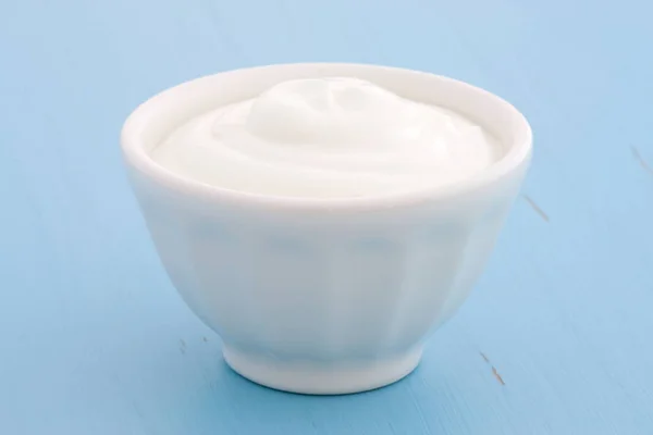 Delicious, nutritious and healthy fresh plain greek  yogurt on antique wood table