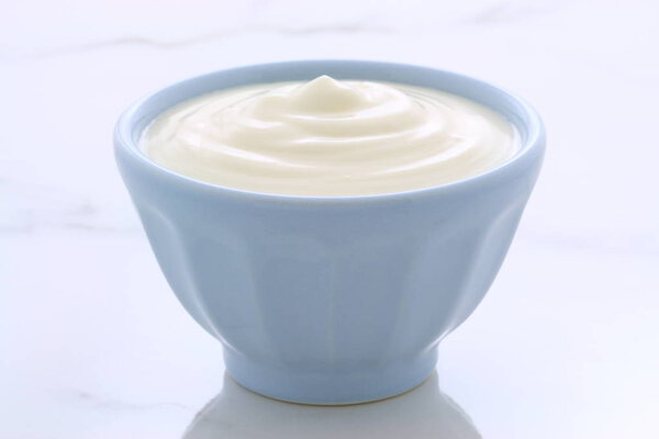 Delicious, nutritious and healthy fresh plain yogurt on vintage italian carrara marble setting.