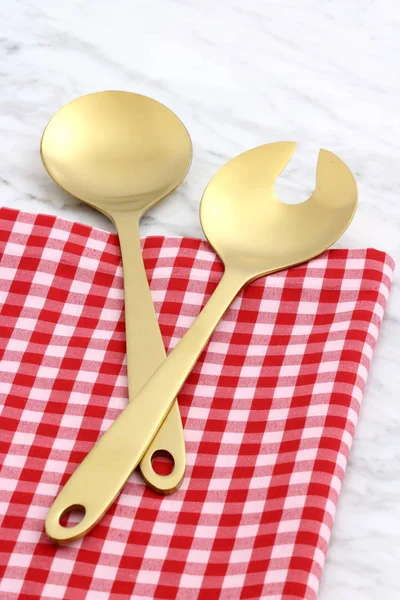 Beautiful golden salad servers — Stock Photo, Image