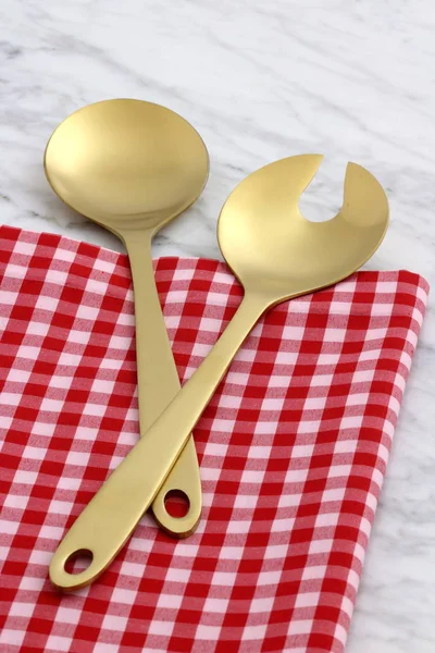 Beautiful golden salad servers — Stock Photo, Image