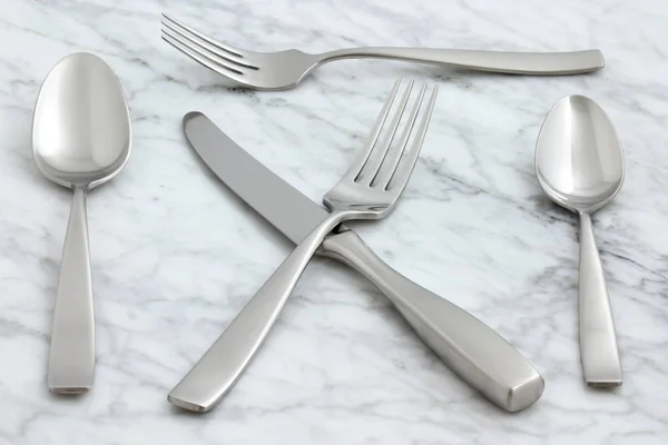 Beautiful silverware on carrara marble — Stock Photo, Image