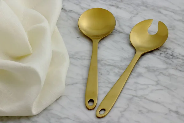 beautiful golden serving spoon and fork