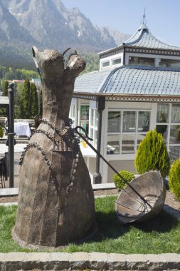 Busteni, Romania - April 30, 2018: Metal dress with an umbrella at the Cantacuzino Palace (Palatul Cantacuzino) from Busteni, Romania