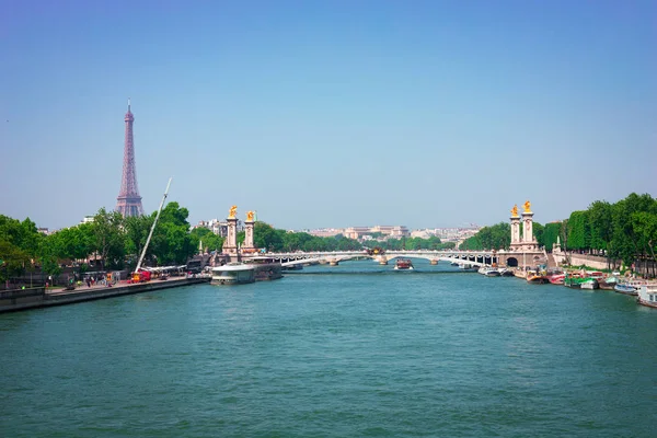 View on the bridge of Alexander III crossing the Seine river and the EIffel tower, Paris, France.