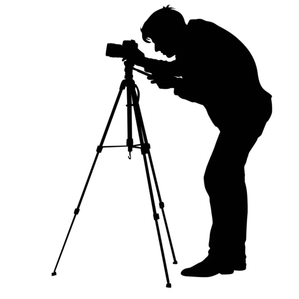 Cameraman con videocamera. Silhouette su sfondo bianco. Illustrazione vettoriale — Vettoriale Stock