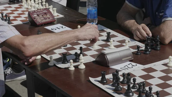 Chess players play a game of chess in a tournament
