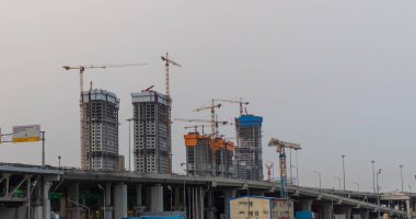 Bir sürü vinç. Mavi gökyüzüne karşı gökyüzü, bulutlu kule turnaları